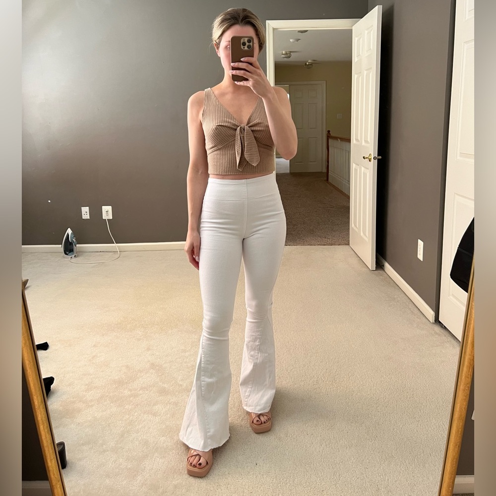 Flare white jeans. Distressed bottom hem. Size S. From Red dress boutique
